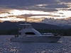 Twilight backlights a game fishing boat.