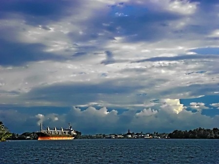 A ship with Madang in the background and the Finisterre Mountains in the distance