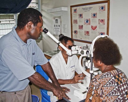 Melissa and a student examining a patient